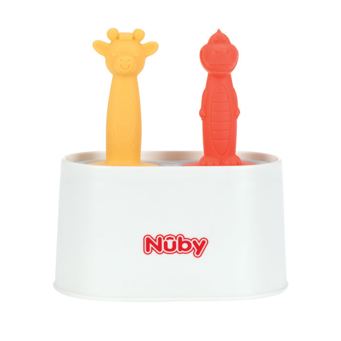 A white Nuby container holds two animal-shaped silicone baby toothbrushes—a yellow giraffe and a red dinosaur—that resemble the playful shapes of the Nuby Animal Pops Ice Pop Mold for homemade popsicles.