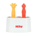 A white Nuby container holds two animal-shaped silicone baby toothbrushes—a yellow giraffe and a red dinosaur—that resemble the playful shapes of the Nuby Animal Pops Ice Pop Mold for homemade popsicles.