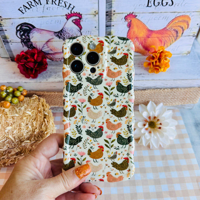 Cluckin' Cute Wavy Luxe MagSafe Case for iPhone â The adorable pattern features a flock of chickens, roosters, and hens pecking among wildflowers, leaves, and botanical elements on a soft cream bac...
