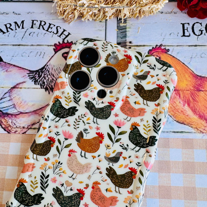 Cluckin' Cute Wavy Luxe MagSafe Case for iPhone â The adorable pattern features a flock of chickens, roosters, and hens pecking among wildflowers, leaves, and botanical elements on a soft cream bac...