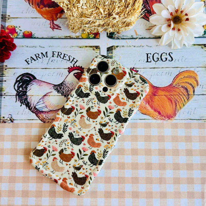 Cluckin' Cute Wavy Luxe MagSafe Case for iPhone â The adorable pattern features a flock of chickens, roosters, and hens pecking among wildflowers, leaves, and botanical elements on a soft cream bac...
