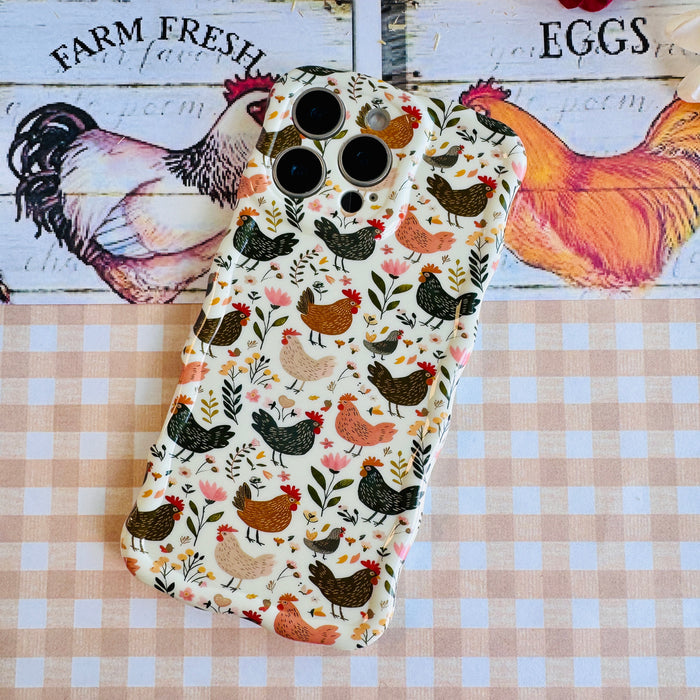 Cluckin' Cute Wavy Luxe MagSafe Case for iPhone â The adorable pattern features a flock of chickens, roosters, and hens pecking among wildflowers, leaves, and botanical elements on a soft cream bac...