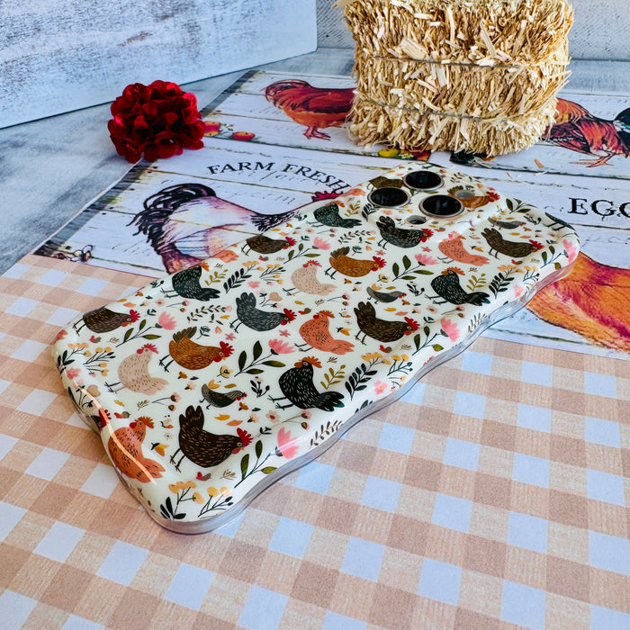 Cluckin' Cute Wavy Luxe MagSafe Case for iPhone â The adorable pattern features a flock of chickens, roosters, and hens pecking among wildflowers, leaves, and botanical elements on a soft cream bac...