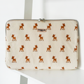 Beige fleece laptop sleeve with a pattern of small brown deer on a white background.