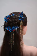 A woman wearing a handmade Chanhua imitation Diancui hair set with colorful flowers and tassels