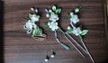 A set of handmade Chanhua jasmine - themed hair accessories in a wooden tray-2