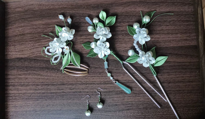 A set of handmade Chanhua jasmine - themed hair accessories in a wooden tray-2
