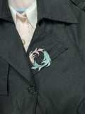 A handmade Chanhua Qiyu little fish brooch on a black coat