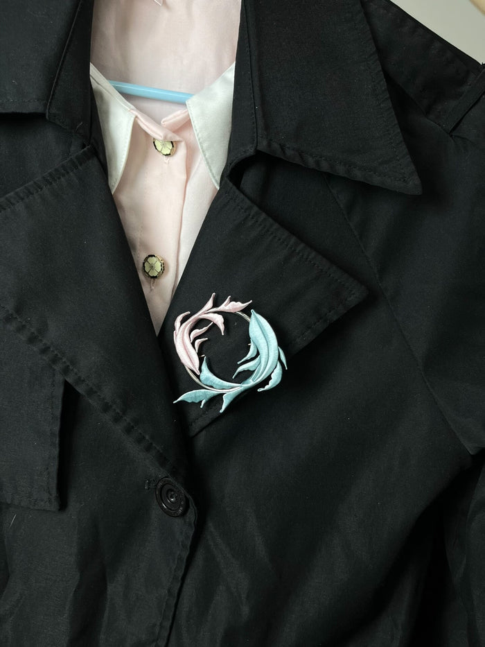 A handmade Chanhua Qiyu little fish brooch on a black coat-6