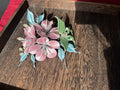 A handmade Chanhua morning glory hairpin with pink flowers and blue - green leaves on a wooden tray
