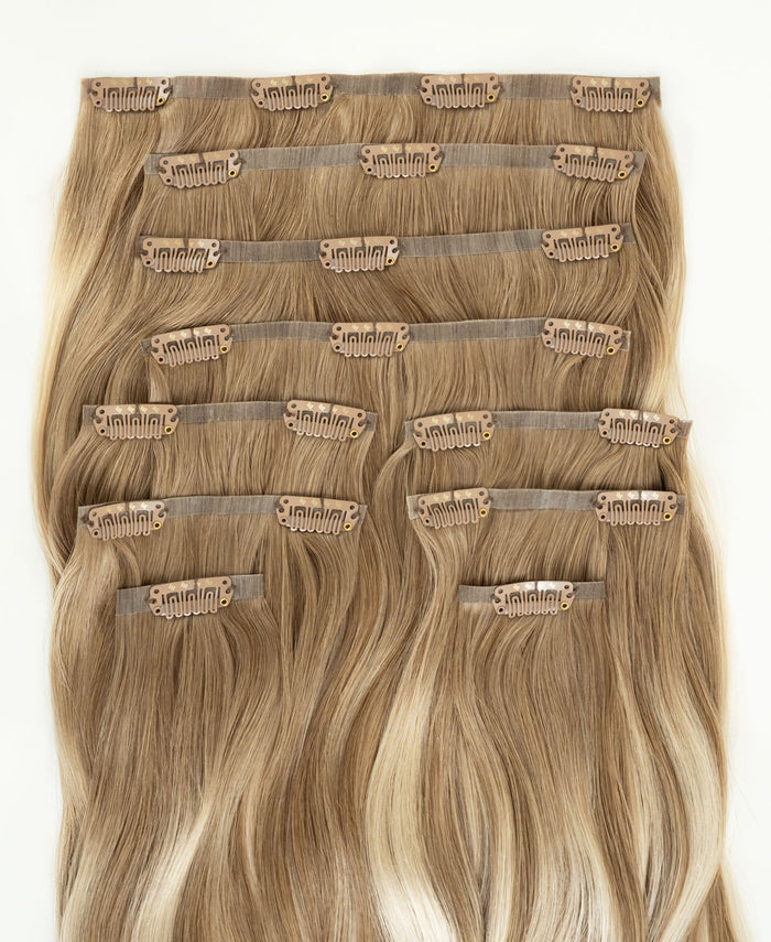 invisible clip-in hair extensions rooted blonde highlights.