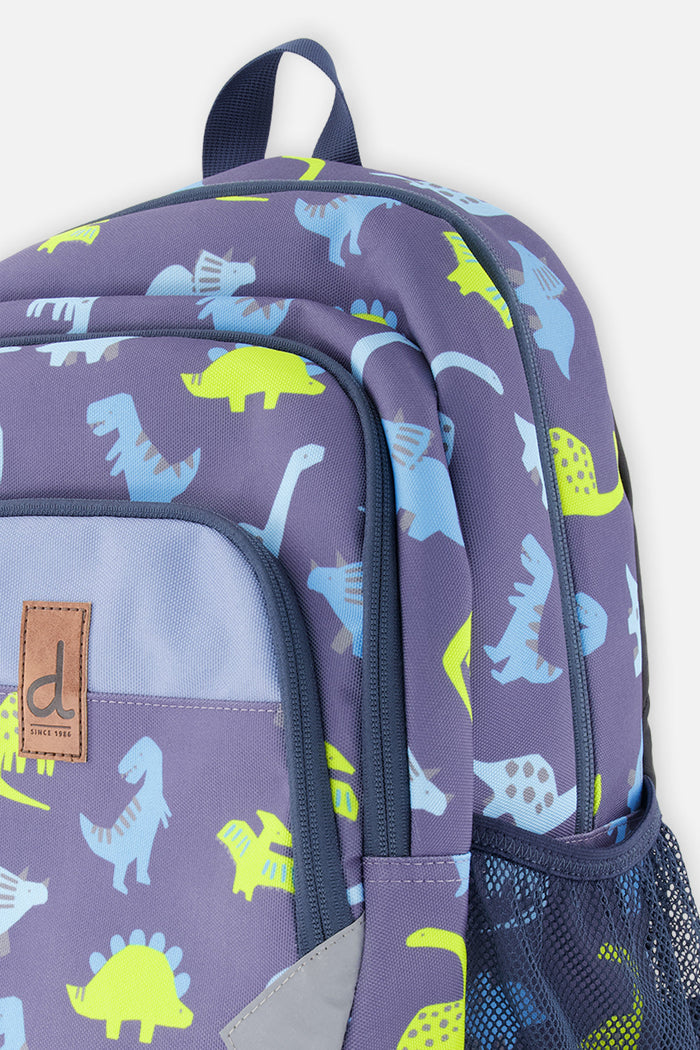 Closeup of Deux par Deux dinosaur backpack with printed compartments, zippers, and side pocket detail.
