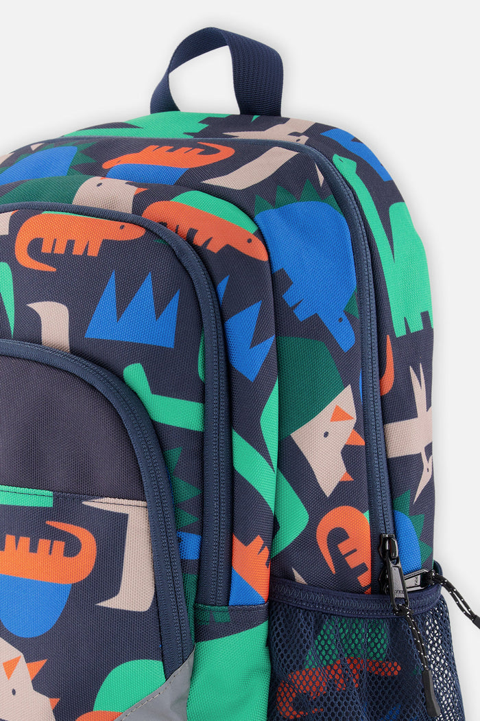 Closeup of Navy dinosaur backpack with printed compartments, side pocket, and zipper detail.