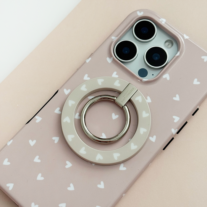 Coconut Lane MAGSAFE® phone ring with chai heart pattern on a smartphone in a pink heart-patterned case.