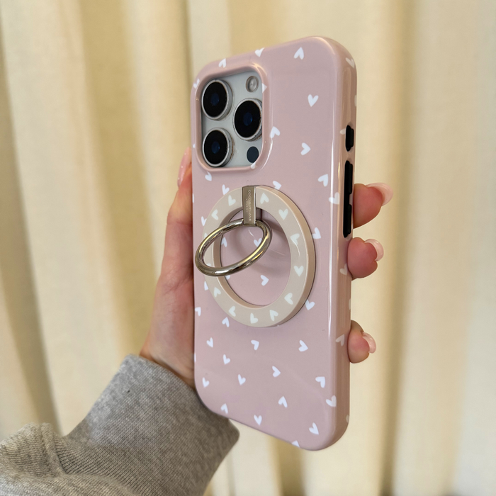 Coconut Lane MAGSAFE® Phone Ring - Chai Hearts on a pink phone case with white hearts, held in a hand.