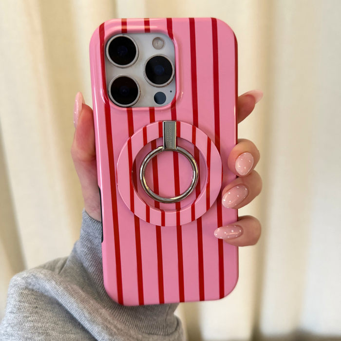 Hand with pink nails holding a phone in a Coconut Lane Cherry Stripes MAGSAFE® case with attached phone ring.