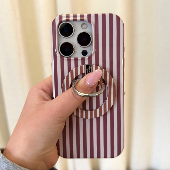 Hand with pink nails holding a phone featuring a Coconut Lane Chestnut Stripes MAGSAFE® phone ring.