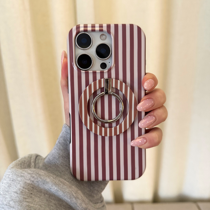 Hand with long pink nails holding a phone featuring a Coconut Lane MAGSAFE® phone ring in chestnut striped design.