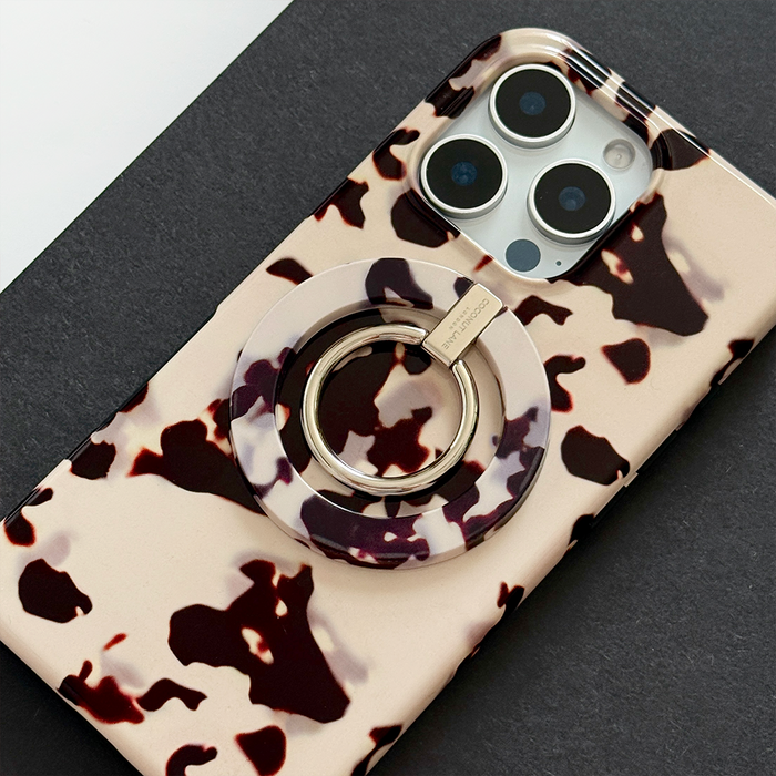 Ivory Tort Coconut Lane MAGSAFE® phone ring case displayed on a black and white surface.