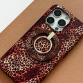 Smartphone with a leopard print case and MAGSAFE® phone ring on a brown surface.