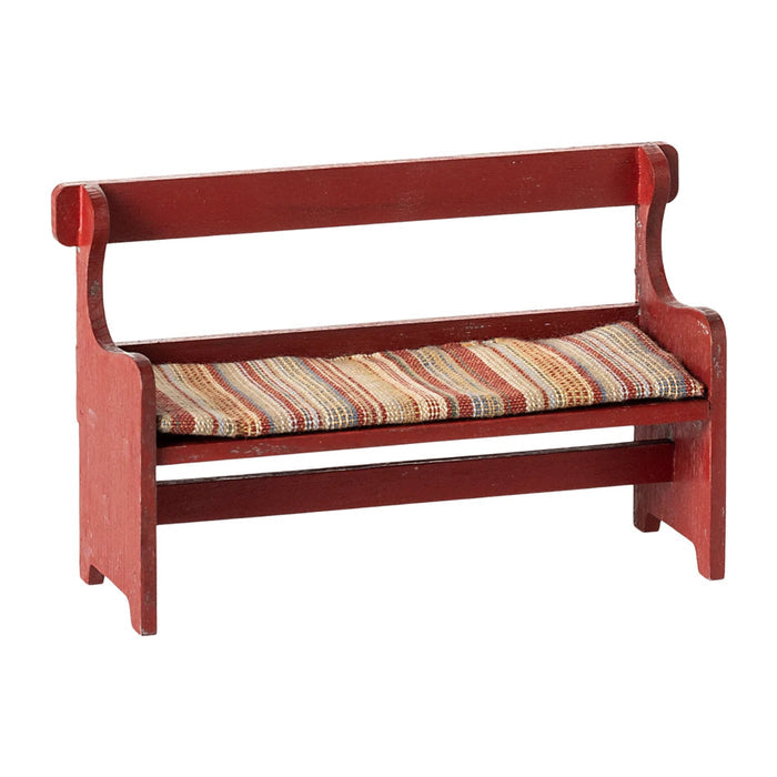 Red wooden bench with a striped cushion on a white background