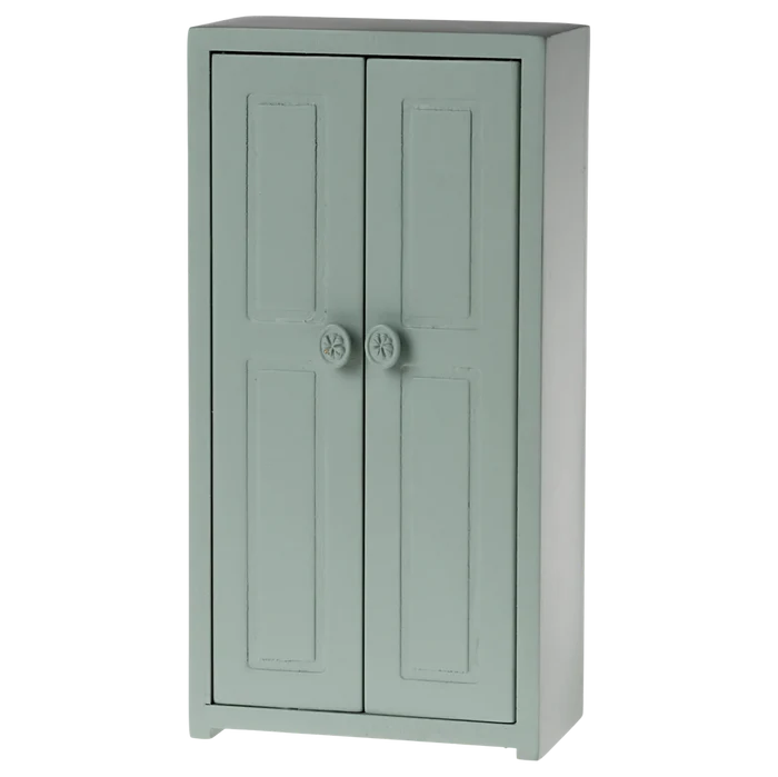 A small toy closet for mice with a soft blue color, featuring two doors and three golden hangers.