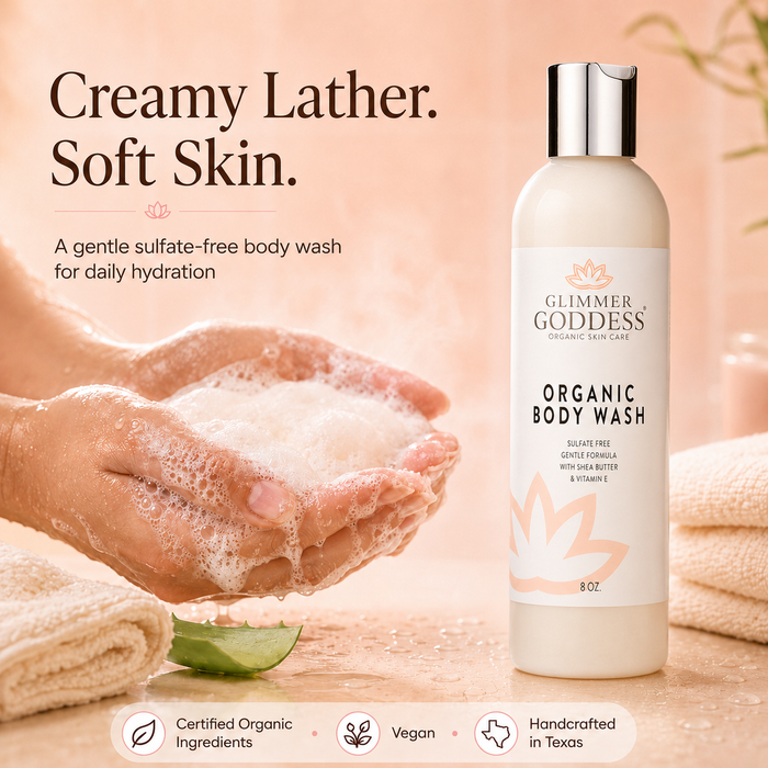 Glimmer Goddess Organic Moisturizing Body Wash lifestyle image on a soft Peach background, showing the exact product bottle on the right beside creamy sulfate-free lather in clean wet hands, highlighting soft hydrated-feeling skin, Certified Organic Ingredients, vegan body care, and handcrafted in Texas.