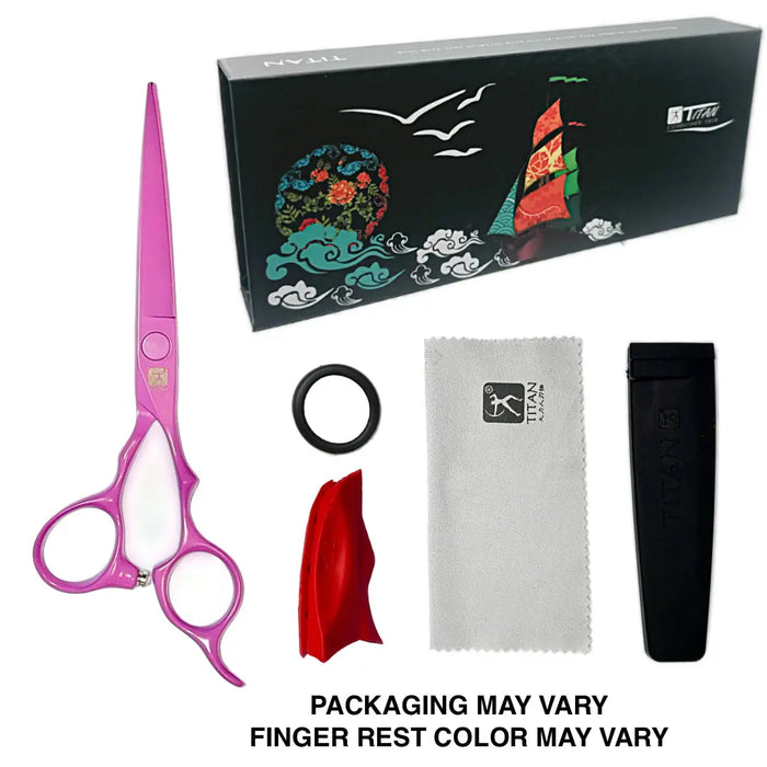 Titanium hair styling scissors with pink handles and white finger rests, shown with a black branded box, a black ring, a white microfiber cloth, a red fabric sleeve, and a black sheath on a white background.
