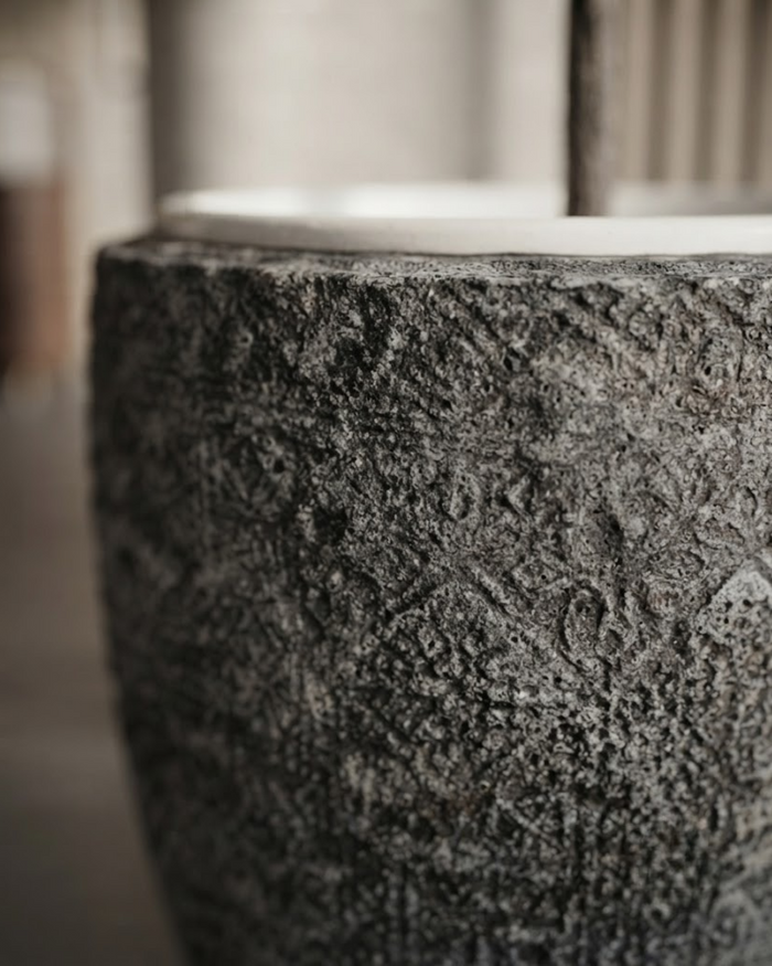 Round decorative planter with dark gray textured pattern and wide rim