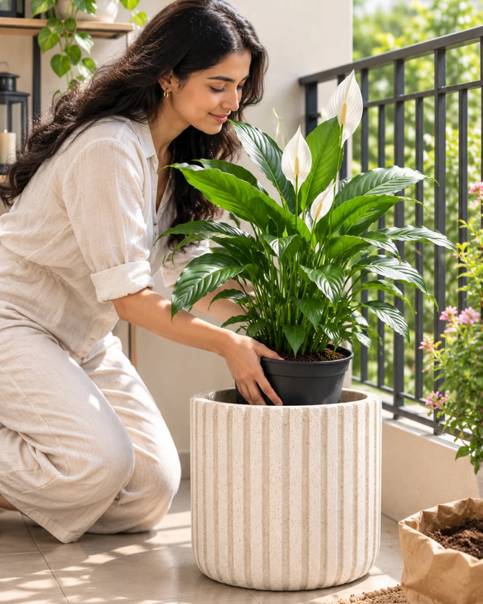 Vertical stripe planter with potted green plant, beige vertical ridges