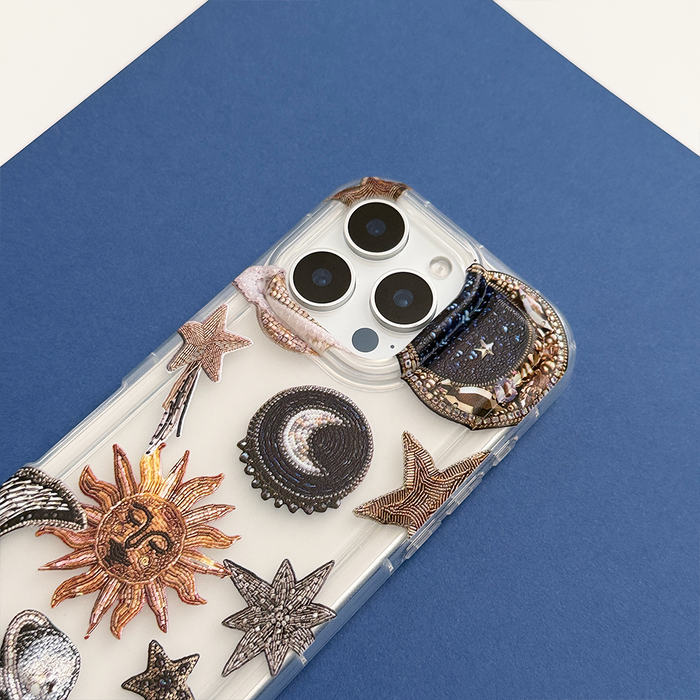 Clear phone case with celestial sun, moon, and star print by Coconut Lane.