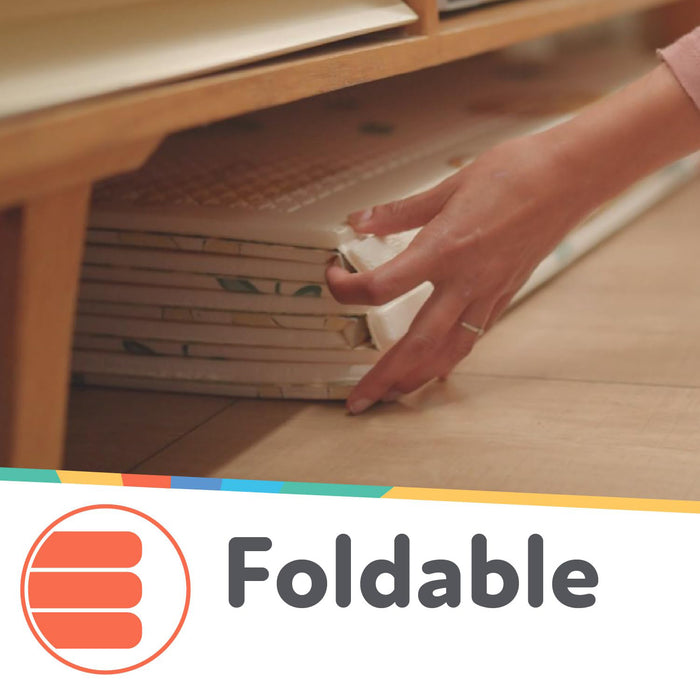 A hand slides the Reversible Floor Mat | Safari under a wooden shelf. The word "Foldable" and an icon with three stacked lines appear at the bottom of the image.