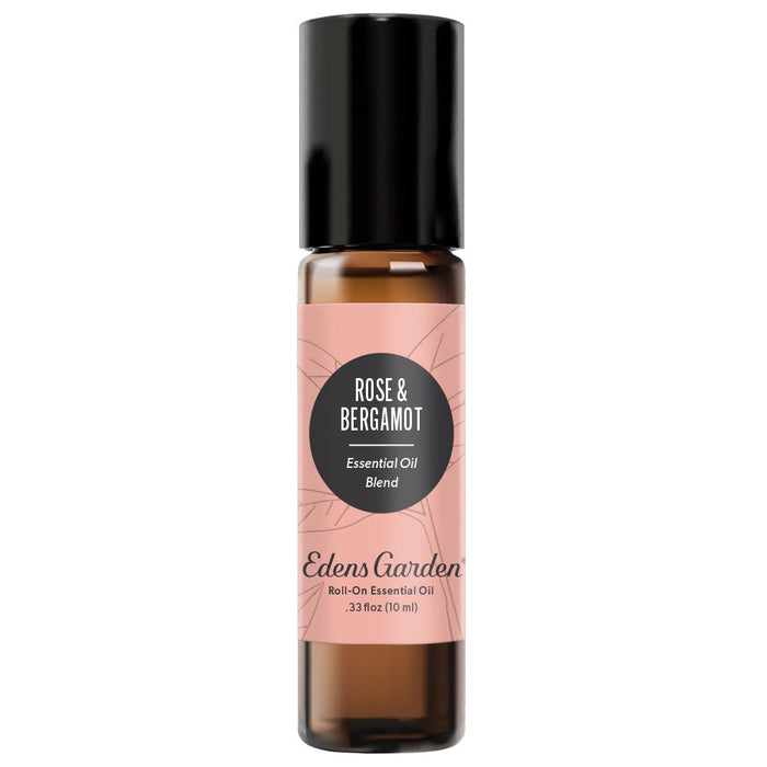 A clear glass roll-on bottle with a black cap and a label reading 'Rose & Bergamot Essential Oil Blend' by Edens Garden.