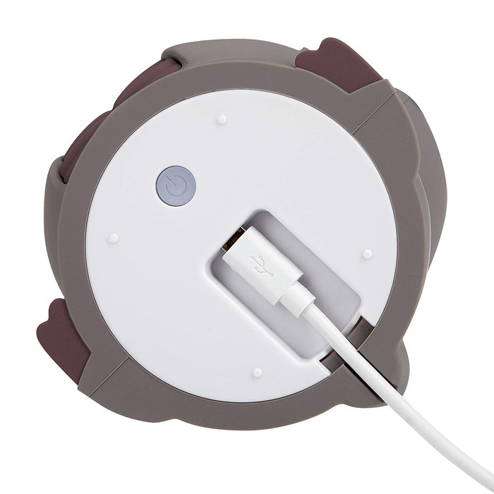 A close-up shows the Silicone Nightlight’s white and brown rounded design, with a USB cable plugged into its port and a nearby power button.