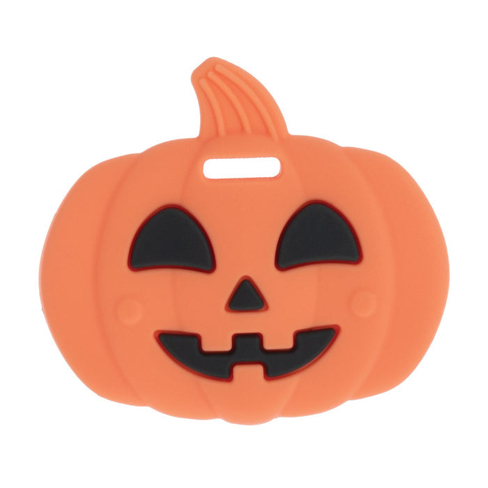 The Nuby Silicone Pumpkin Teether features a friendly jack-o-lantern face with triangular eyes and nose—an orange, cartoon-style teething toy made from safe silicone for babies.
