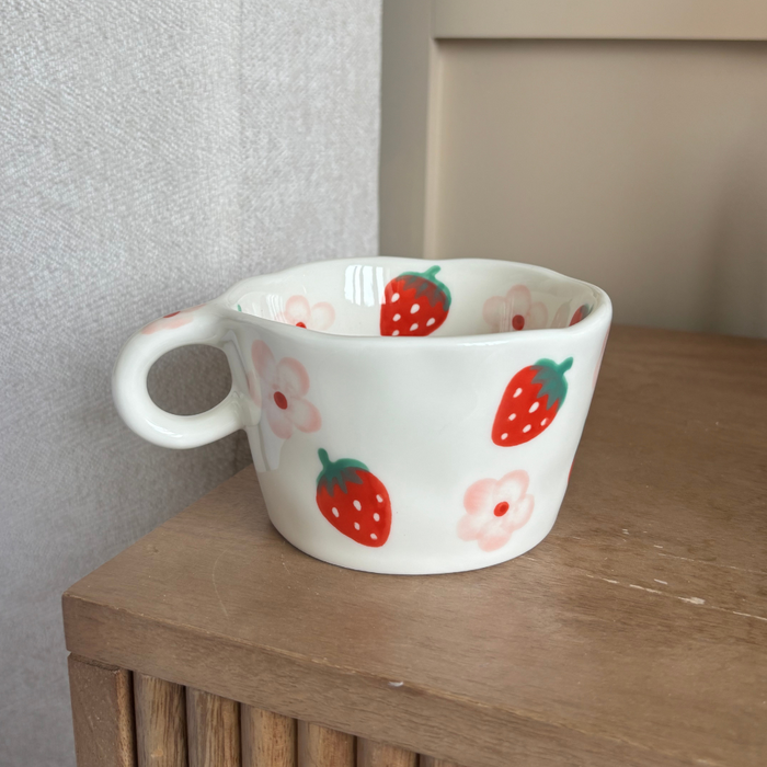 White ceramic mug with pink strawberry and floral pattern from Coconut Lane.