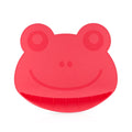 The Nuby Sure Grip Miracle Mat with Food-Catching Pouch pairs perfectly with a red silicone frog face kitchen mitt, offering a convenient, dishwasher-safe solution for gripping hot items and catching food in the kitchen.