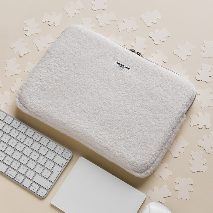 White fluffy sherpa Teddy Dolly laptop sleeve by Coconut Lane, shown on a beige background.