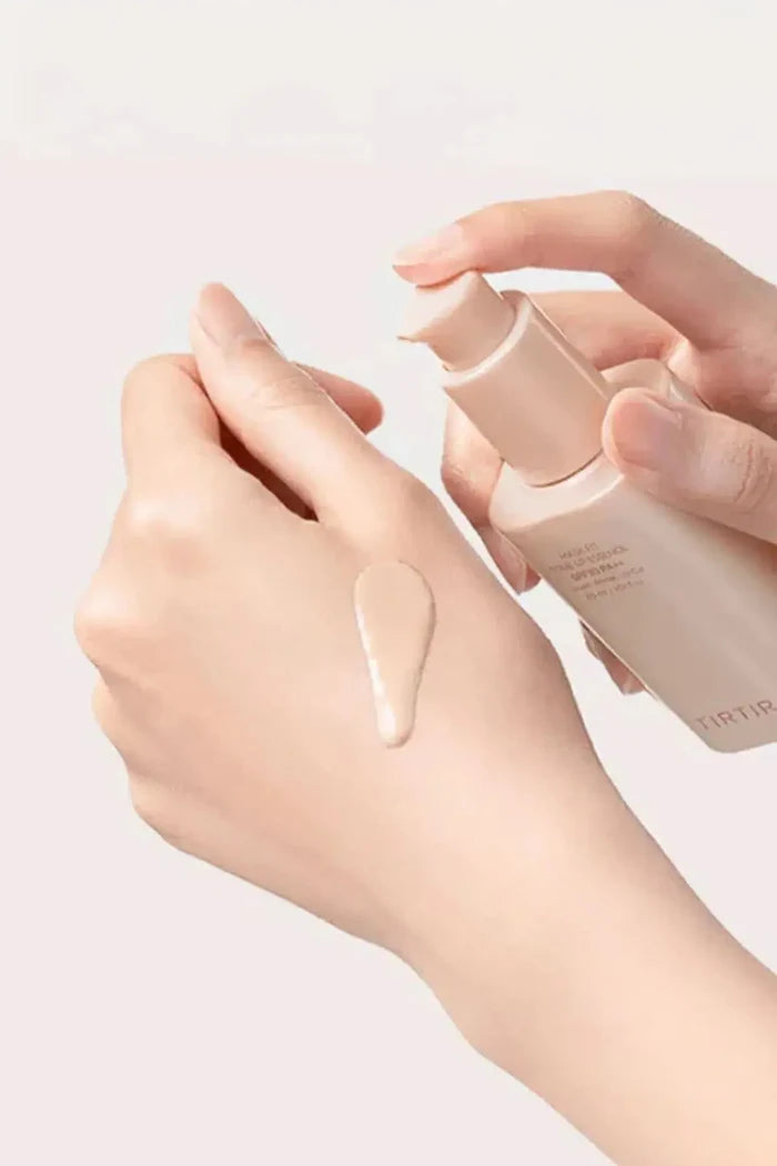 Model holding TIRTIR Tone Up Essence, displaying a smooth and glowing complexion achieved with this Glass Skin Primer.