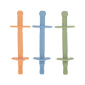 The Nuby Tube Teethers (3 Pack) in orange, blue, and green feature textured silicone surfaces and handles—ideal as a teether or baby teething toy for sensory chewing and oral motor therapy.
