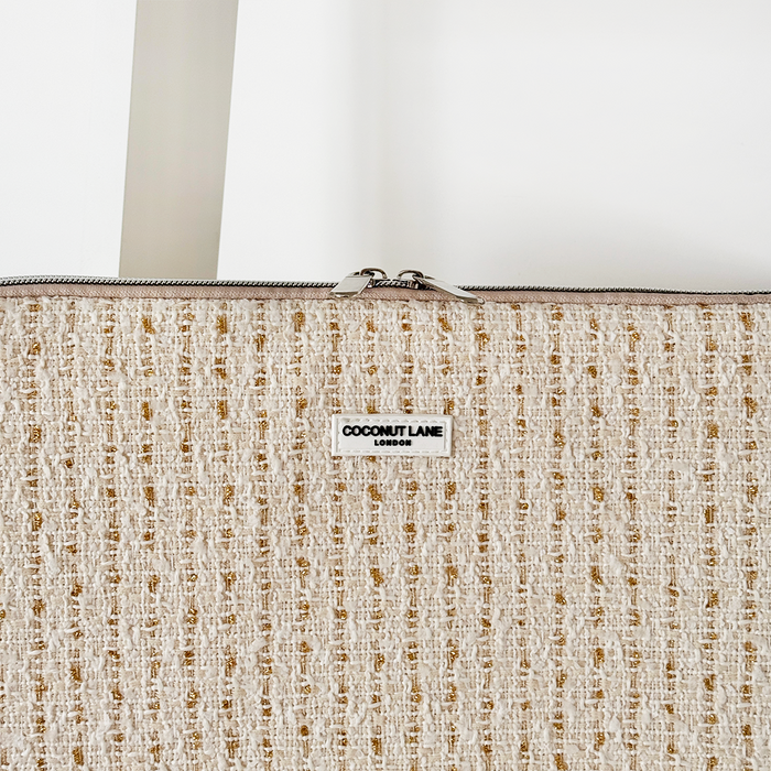 Vanilla textured tweed laptop sleeve with zipper, shown on a white background.