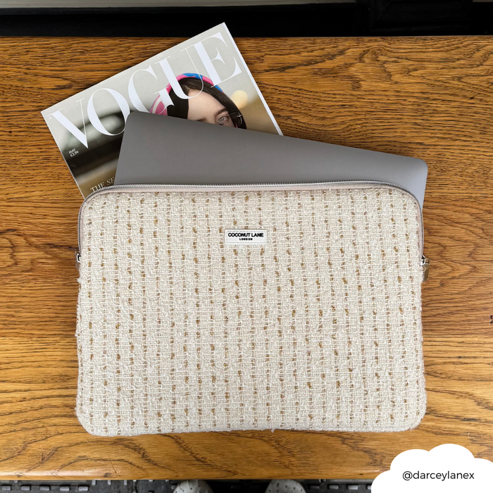 Vanilla textured tweed laptop sleeve from Coconut Lane beside a laptop and Vogue magazine on a wooden table.