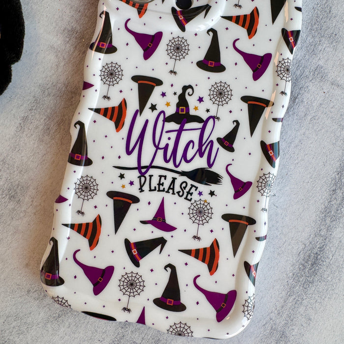Close-up of the Witch Please Wavy Luxe MagSafe iPhone case showing the purple Witch Please script over the witch hat print.