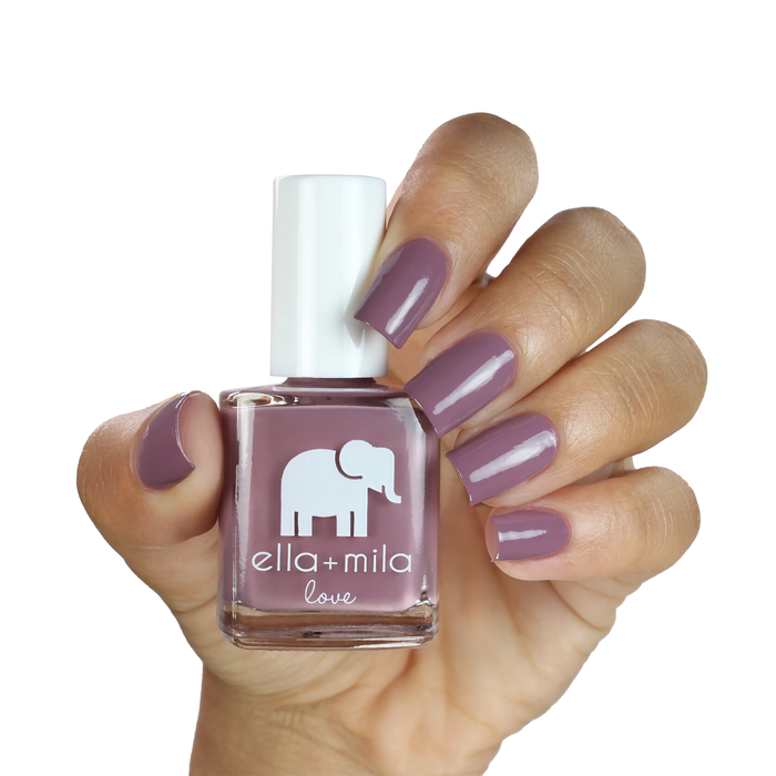 You and Me grey purple brown nail polish on a medium skin tone, hand holding the bottle